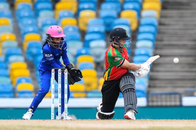 Barbados Tridents Women’s wicketkeeper Mandy Mangru (left) watches as Guyana Amazon Warriors Women’s Tazmin Brits plays a shot during their playoff game at the Kensington Oval in Barbados yesterday.