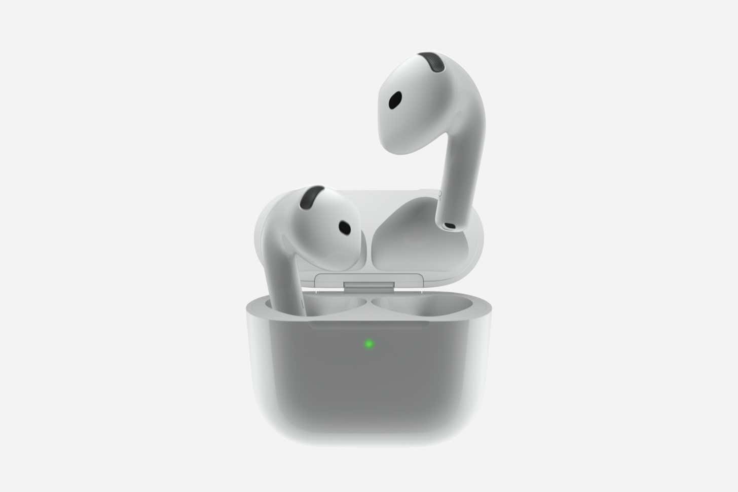 Against a plain light gray background, a pair of Apple AirPods 5 earbuds sit positioned above an open white charging case. One earbud is partially inside the slot, while the second hovers directly above, facing a small green LED light glowing on the front of the case.
