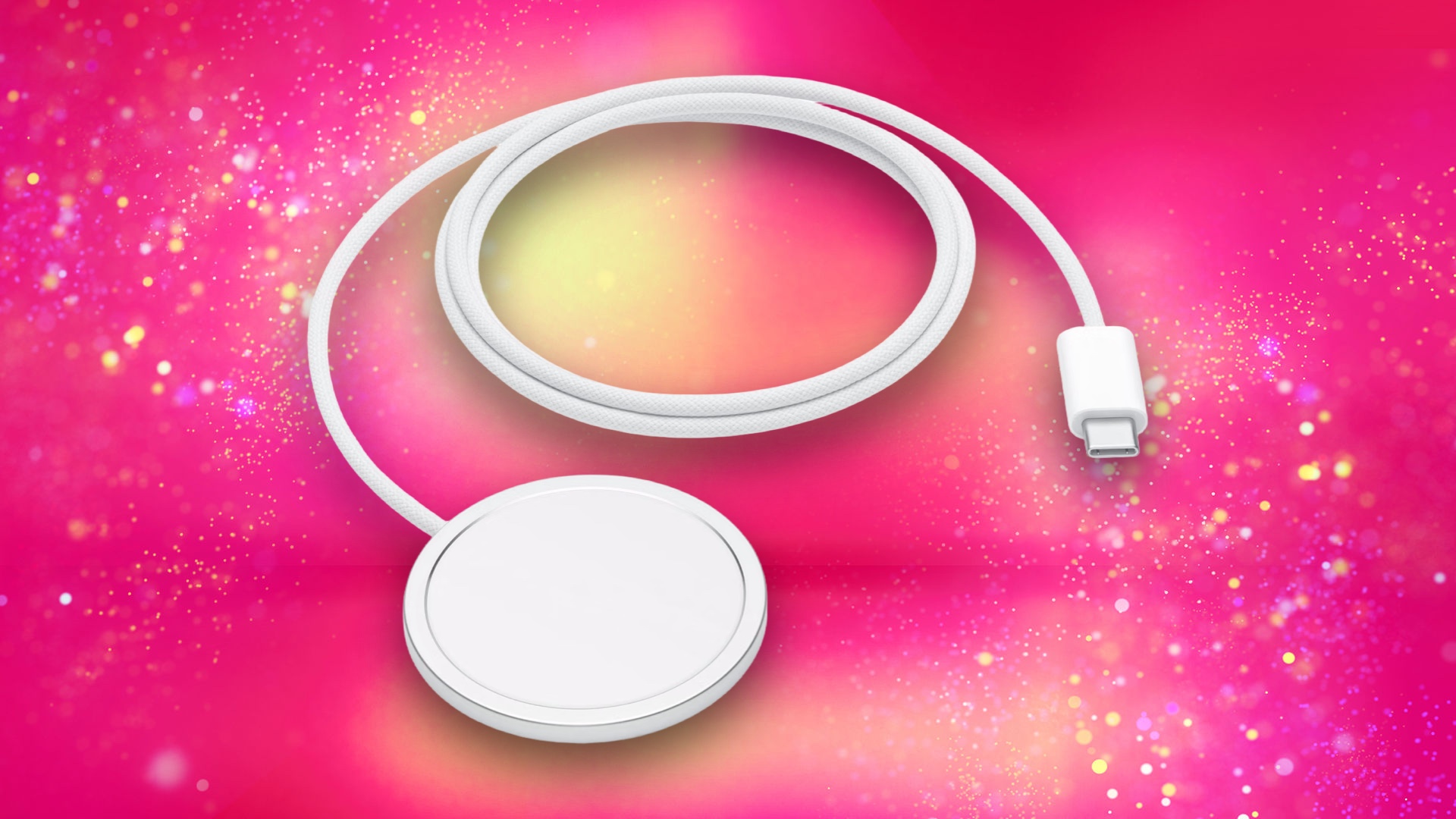 Apple MagSafe charger on a pink background