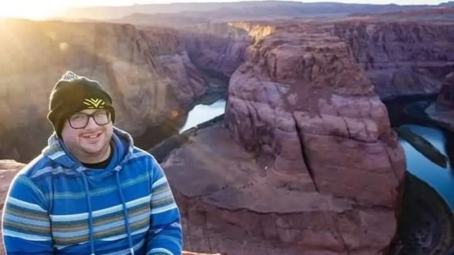 Ben Cronin A man wearing a blue jumper and hat smiling at the camera
