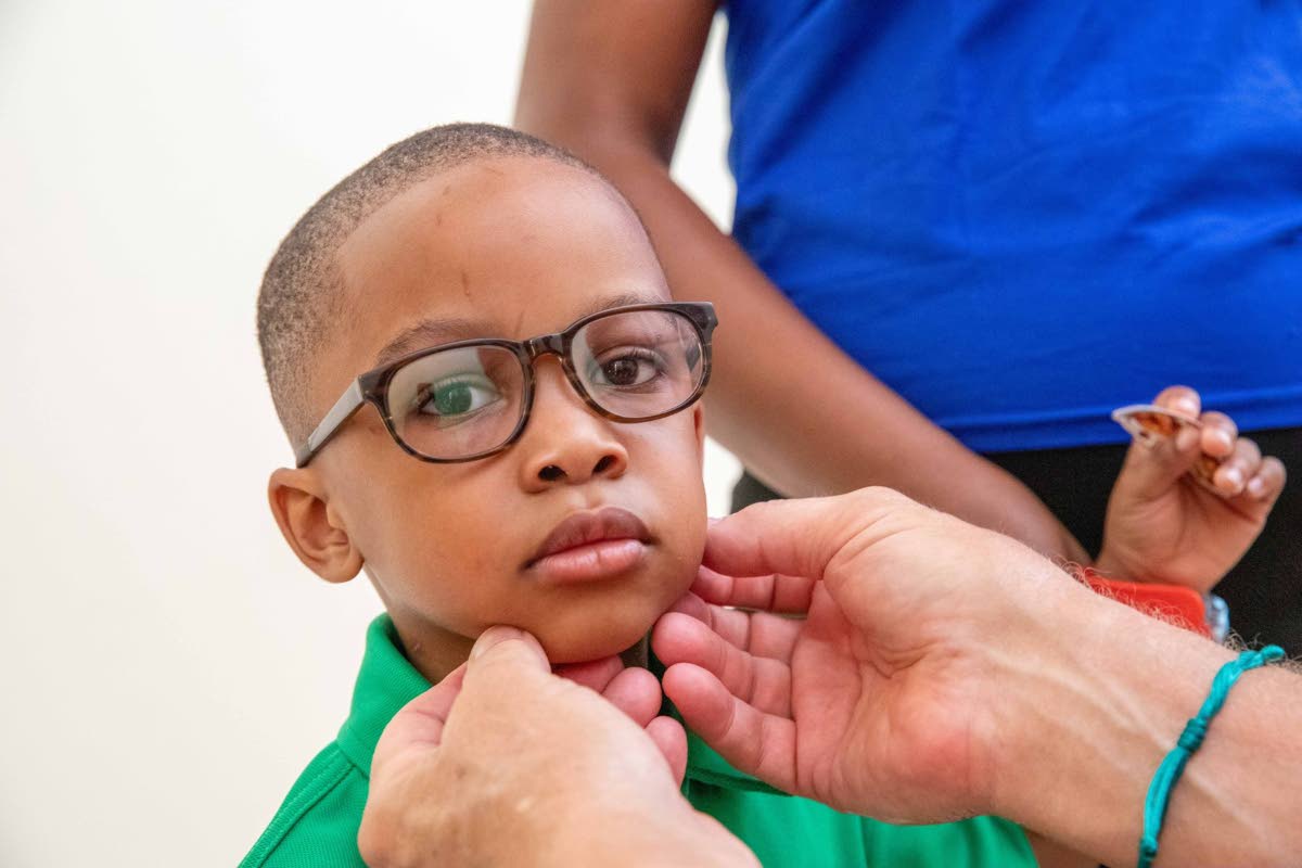 A student of Savanna-la-Mar Inclusive Academy tries on a pair of eyeglasses during a vision screening conducted by the Lions of Michigan Foundation as part of a vision mission at the Westmoreland-based school.