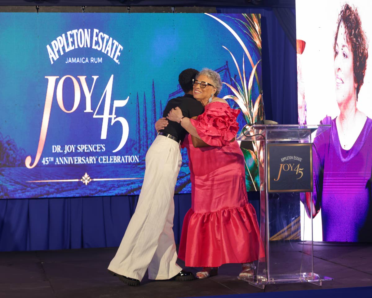 Cara Fraser (left) embraces Dr Joy Spence as the scholarship announcement is made. Fraser, who is pursuing a degree in Food Chemistry at The University of the West Indies, Mona, hopes to become a credible voice in challenging misinformation about food and