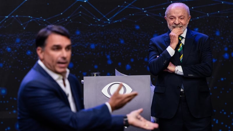 Flavio Bolsonaro, Brazilian presidential candidate, left, and Luiz Inacio Lula da Silva, Brazil's president, during the presidential debate at the TV Band studios in Sao Paulo, Brazil, on Sunday, Oct. 18, 2026. The presidential contest will go to a runoff